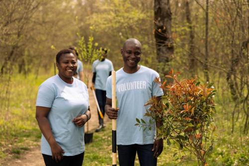 portrait-couple-volunteering-plant-trees-collect-garbage-from-forest_482257-90903